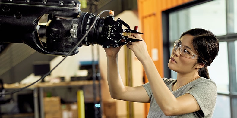 Woman working with AutoCAD and robotics at Autodesk's San Francisco Technology Center.